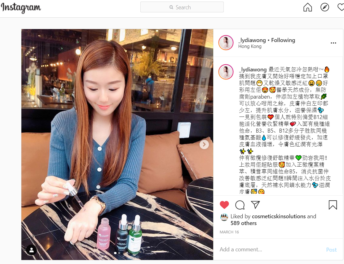 Lydia Wong applying Velvet B12 Peptide Gel to her left hand with other peptide bottles on the table with her.
